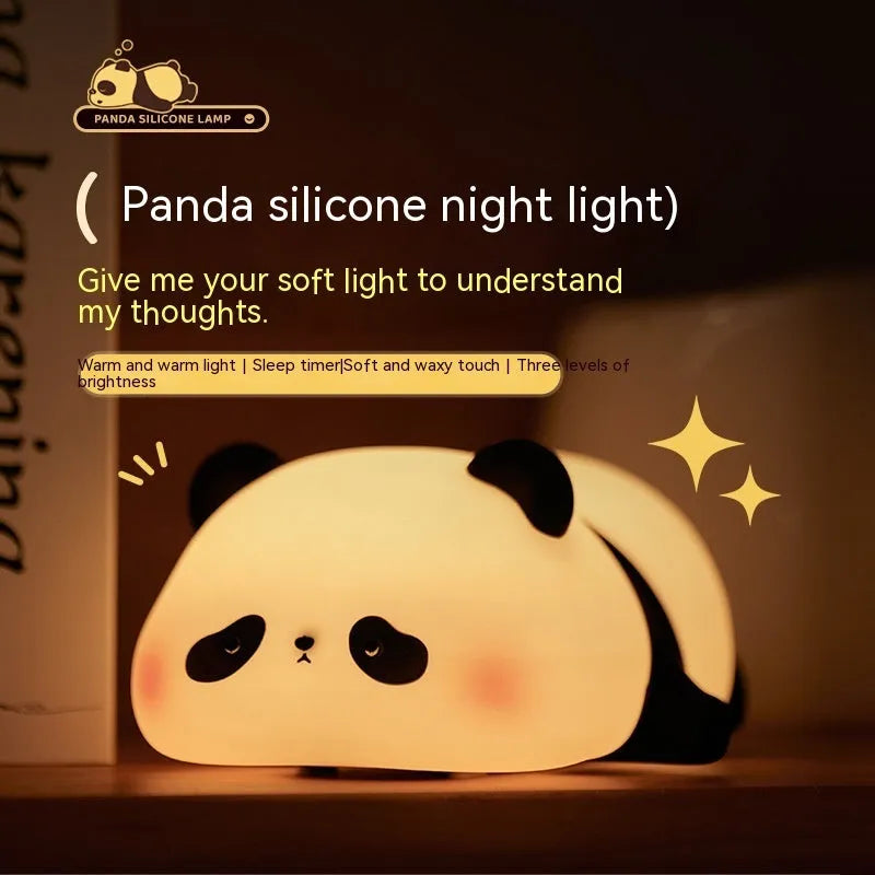 Cute cartoon panda-shaped silicone night light for children on a bedside table.