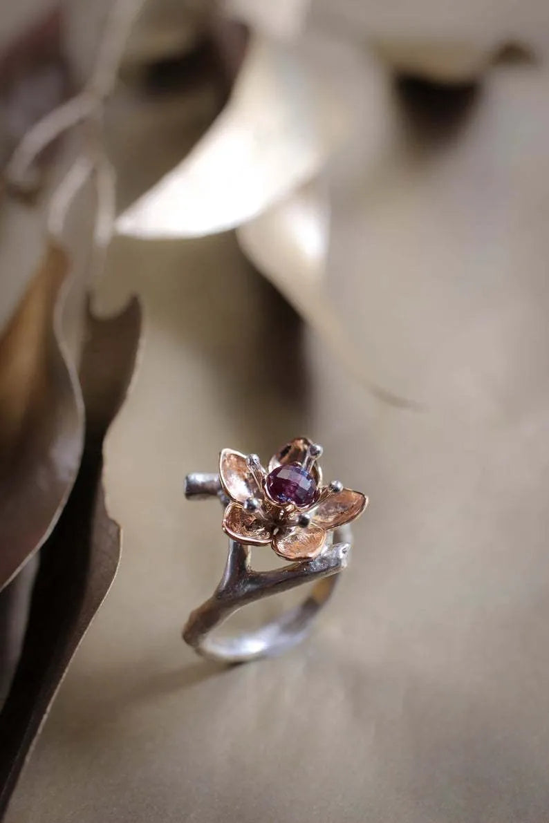 Silver two-tone floral geometric women's alloy ring shown on a finger, demonstrating its design and fit.
