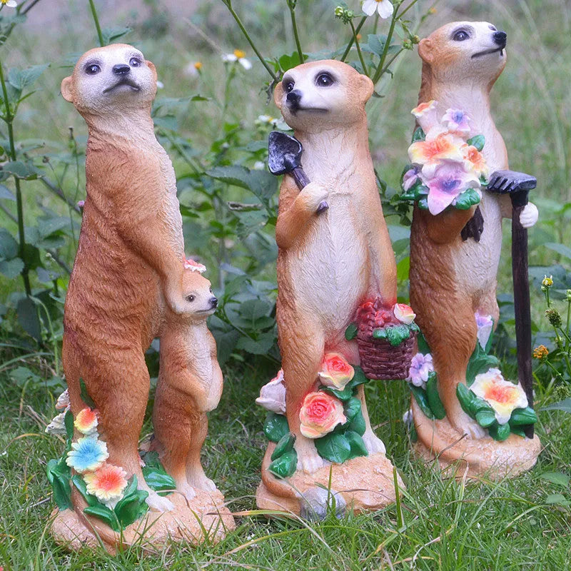 Yellow brown synthetic resin mongoose garden ornament wearing a straw hat and holding a rake or shovel for bonsai decoration