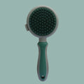 Green and pink dual-sided silicone pet grooming brush with retractable slicker and octopus-toothed massager.