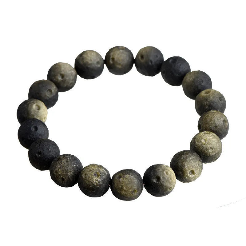 Natural obsidian crater ball bracelet showing distinctive grinding texture on beads