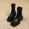 Black women's platform Martin boots with square toe, high heel, and back zip on a white background.