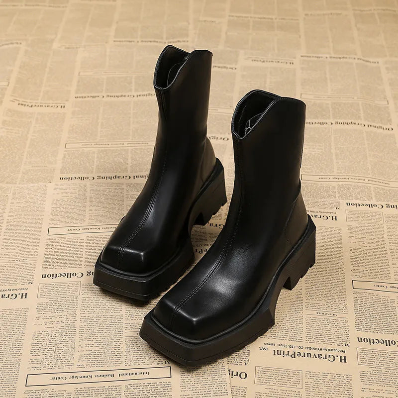 Black women's platform Martin boots with square toe, high heel, and back zip on a white background.