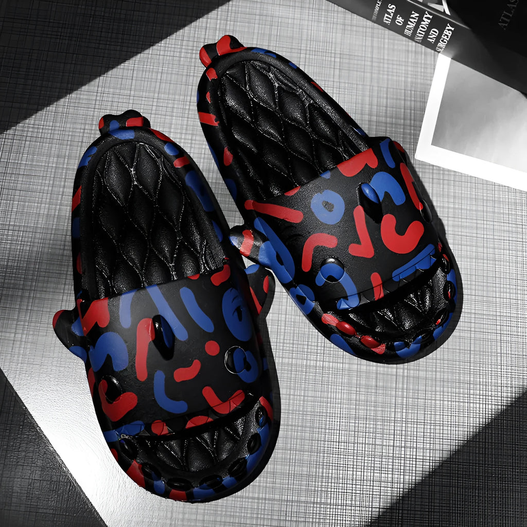 Pair of grey shark design open toe EVA home slippers on a white background.