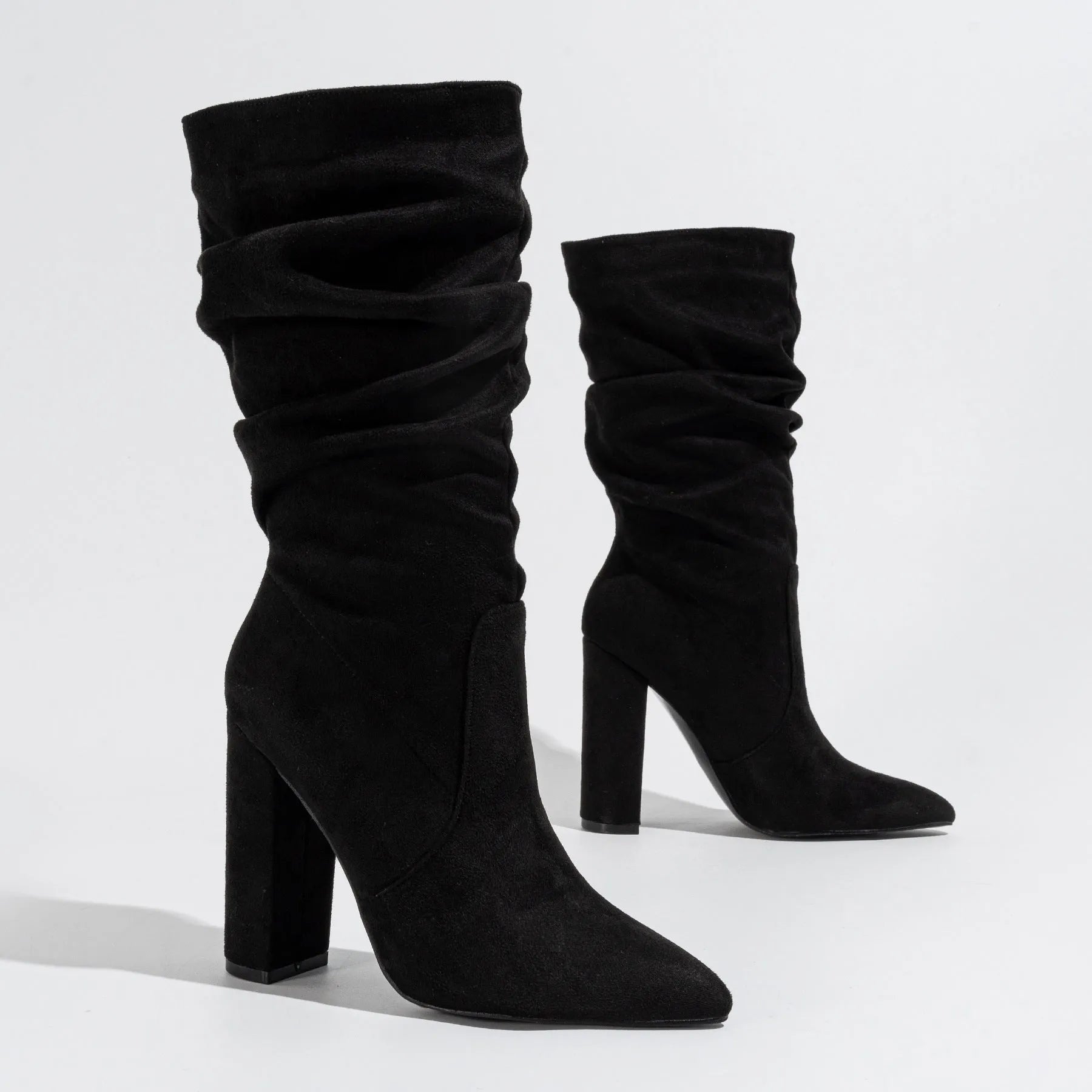 Women's black suede chunky heel boots with pointed toe and mid-calf shaft.