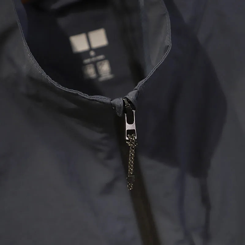 Men's straight-cut nylon vest cardigan in army green with side seam pockets, shown open as a lightweight layer.