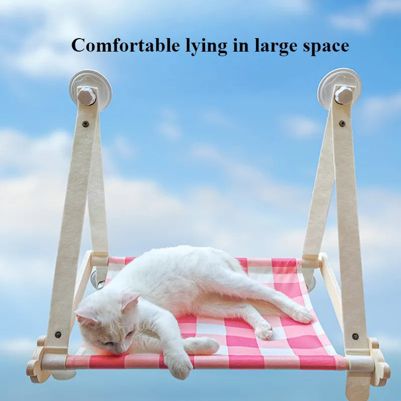 Wooden frame cat window hammock bed with linen fabric attached by suction cups to a window.