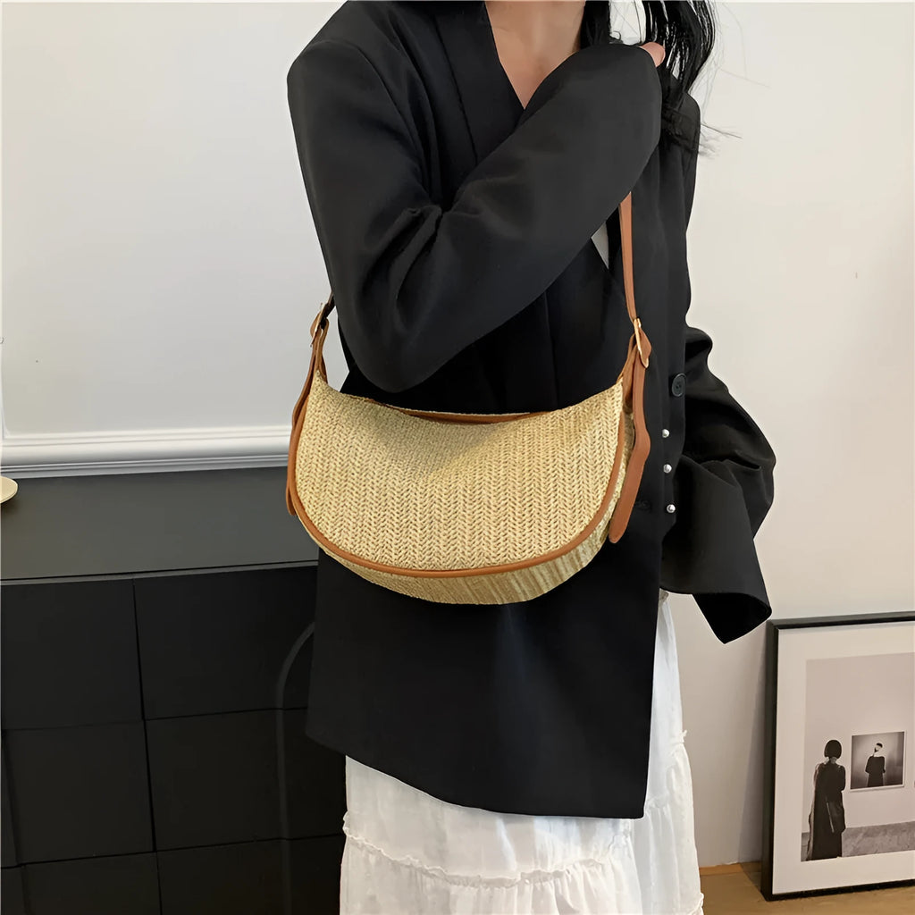 Women's straw woven crossbody bag showing internal mobile phone pocket and file compartment.