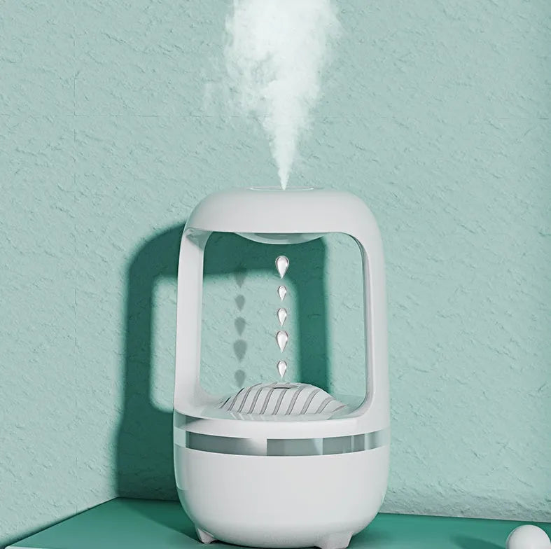 White anti-gravity humidifier with upward-flowing water droplets on dark surface