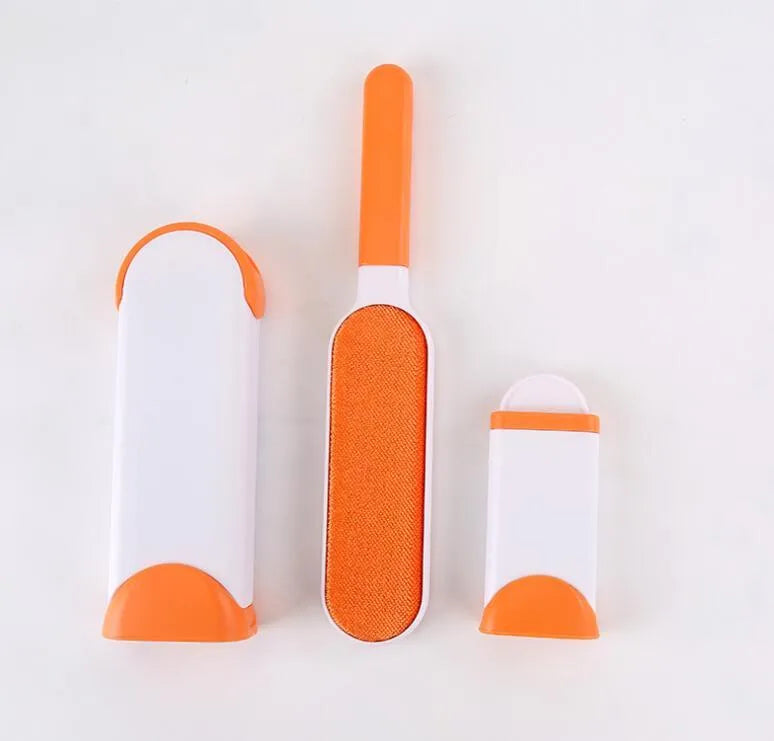 Blue reusable pet hair removal brush with double-sided adhesive head next to its self-cleaning base.
