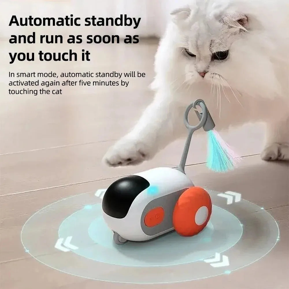 Blue smart cat toy car with feather teaser attachment and remote control on floor