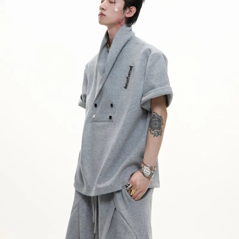 Men's dark grey cotton sports suit with V-neck short sleeve jacket and matching bottoms showing padded shoulder detail