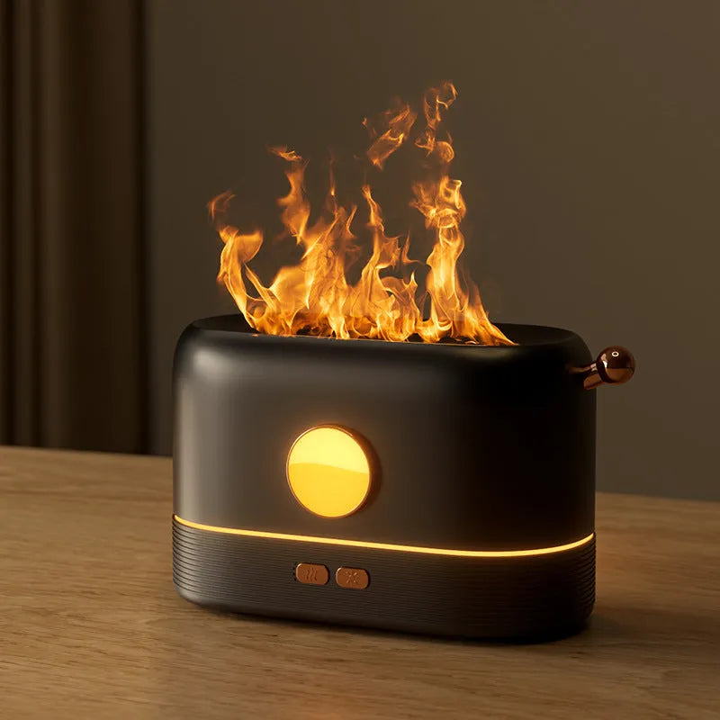 Black USB desktop humidifier diffuser with glowing simulated flame effect on a wooden table.