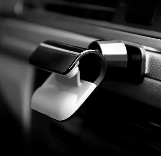 Black universal car phone holder with 360-degree rotation ball joint mounted on dashboard