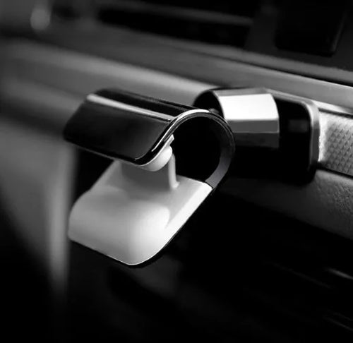 Black universal car phone holder with 360-degree rotation ball joint mounted on dashboard