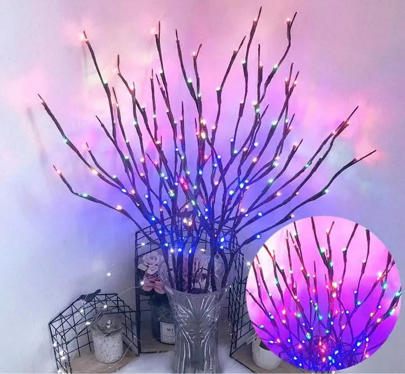 LED decorative tree light with silver branches in a vase, emitting coloured light.