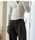 Men's cream apricot coloured ribbed long-sleeve henley top with a three-button placket.
