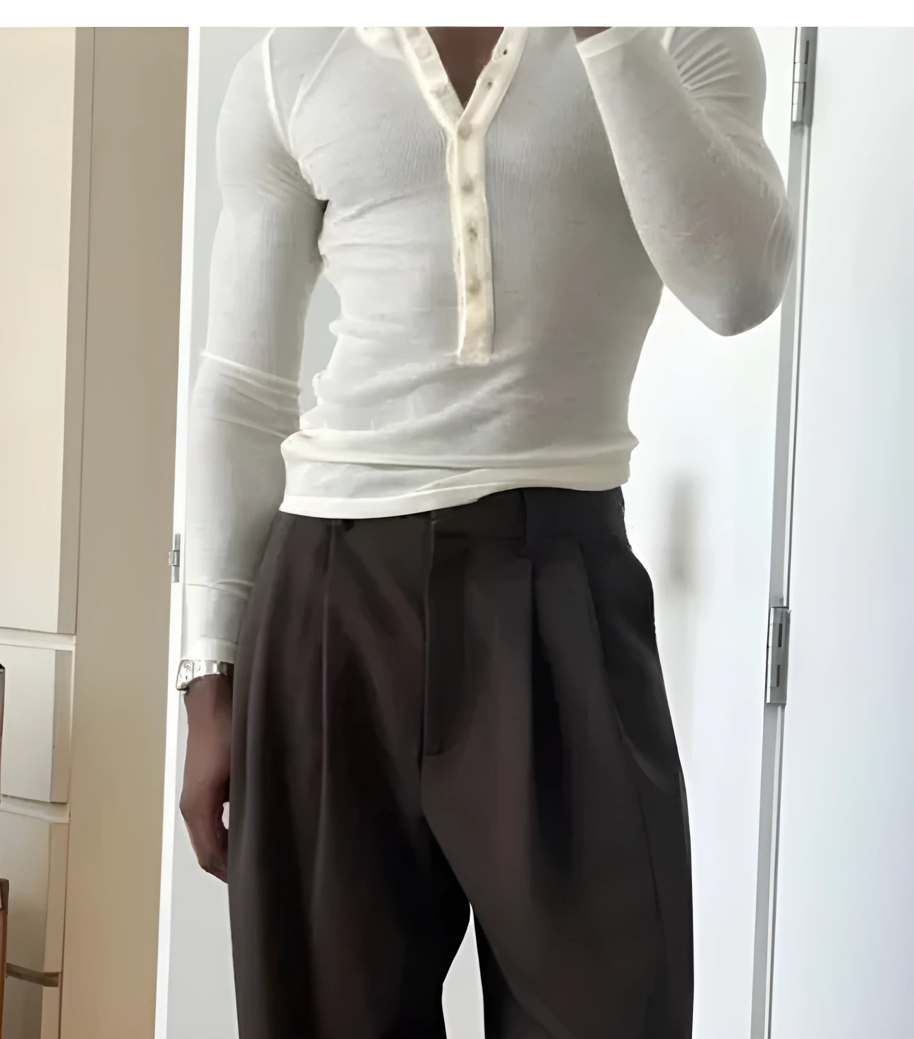 Men's cream apricot coloured ribbed long-sleeve henley top with a three-button placket.
