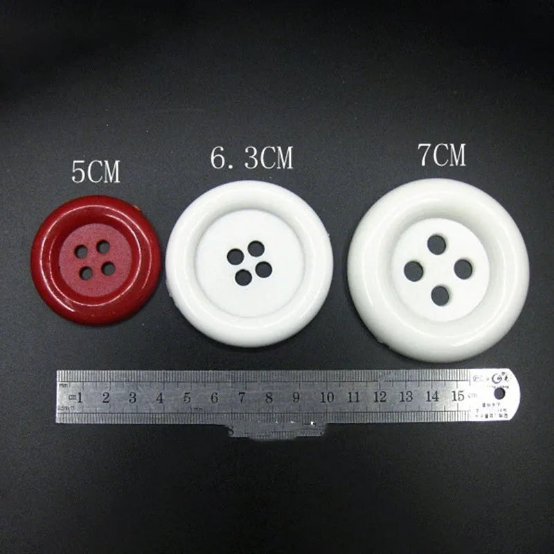 Plastic nylon oversize round sewing buttons in multiple colours showing four-hole design