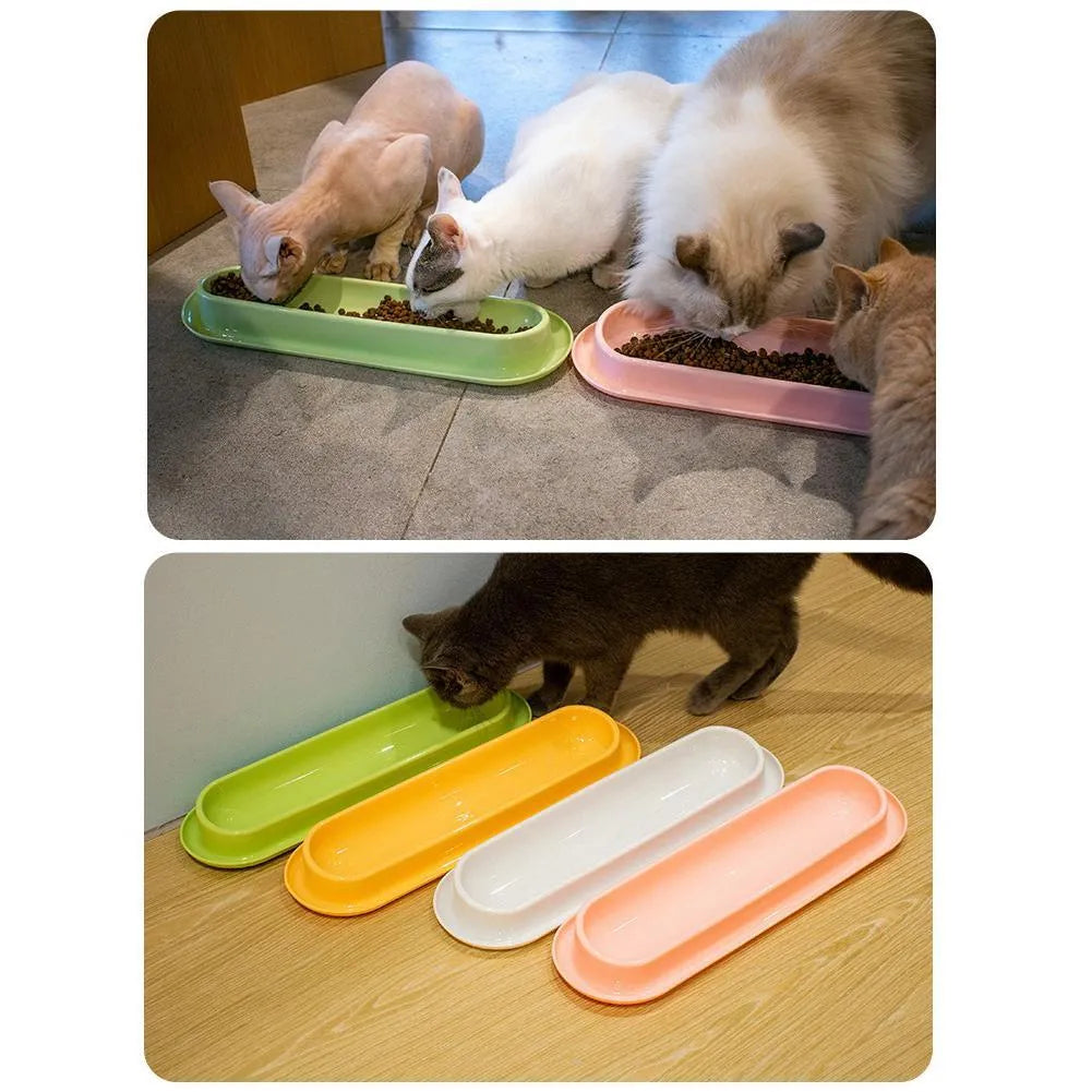 Green double-bowl pet feeder for dog food and water on a floor.