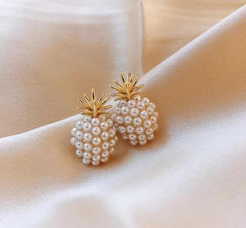 Gold colour Korean-style drop earrings featuring a pineapple and starfish design with pearl and gemstone inlay.