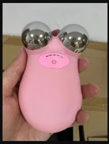 Pink and white micro current facial lifting device for skin firming, showing compact size.