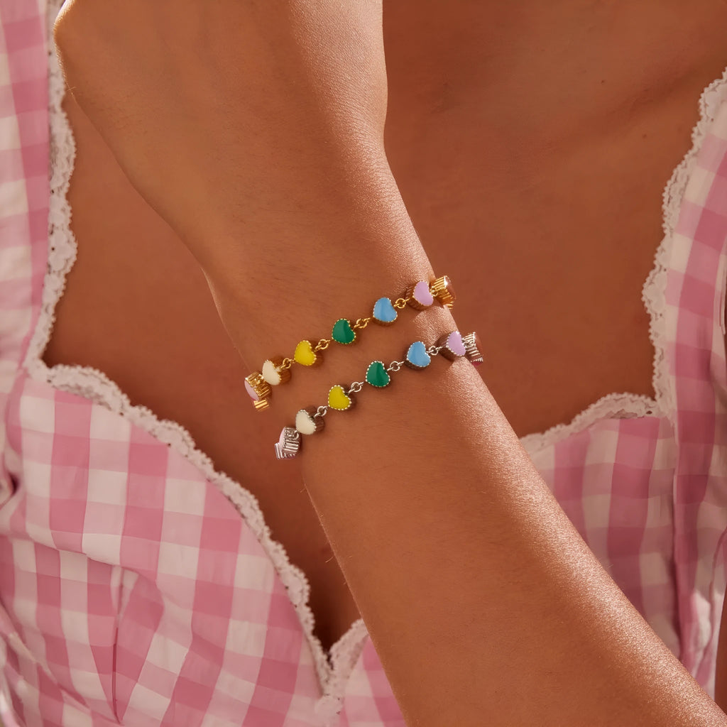 Women's stainless steel bracelet with love heart pendant featuring colourful oil finish in gold or steel colour
