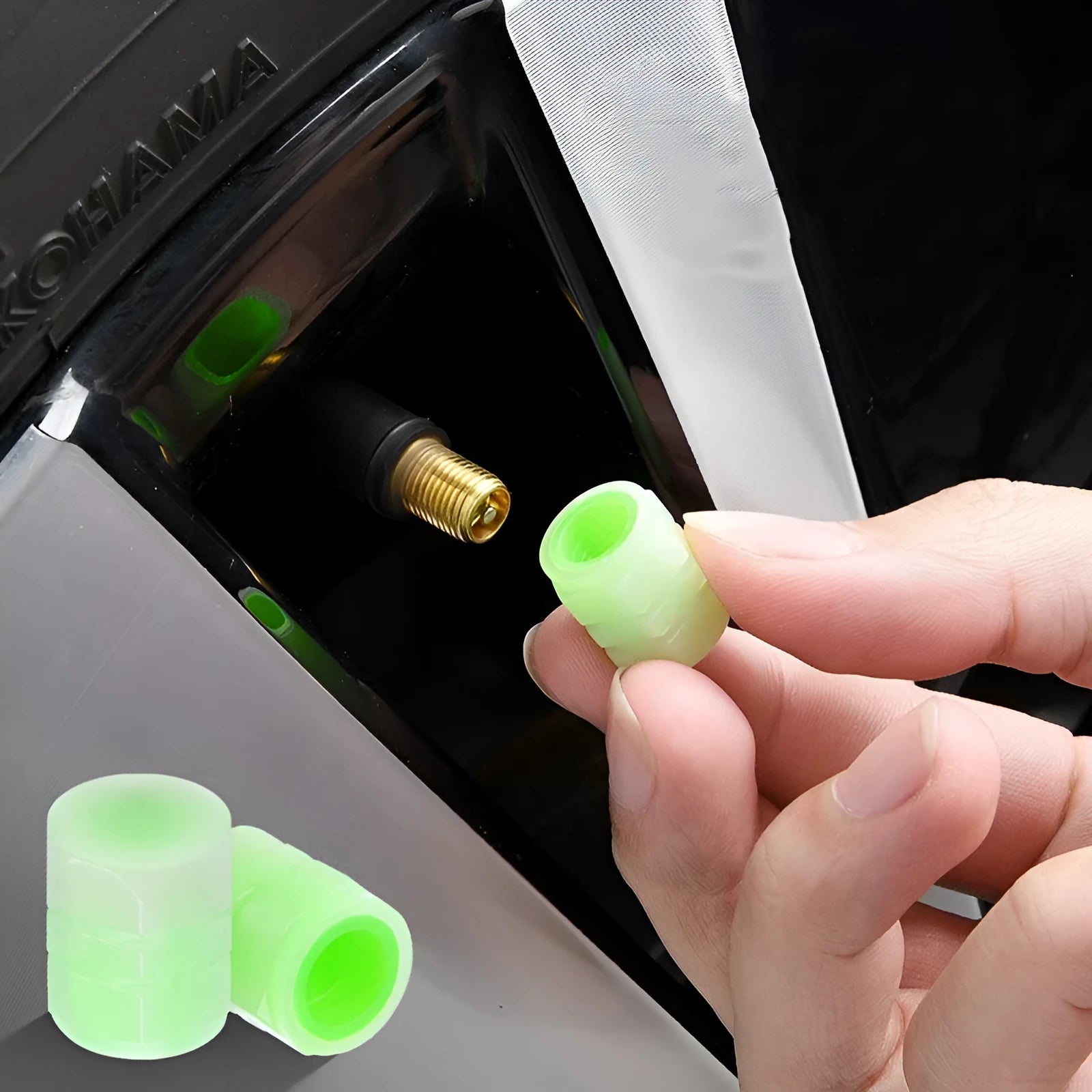 Set of four rubber luminous valve caps for car tyres on a dark background.