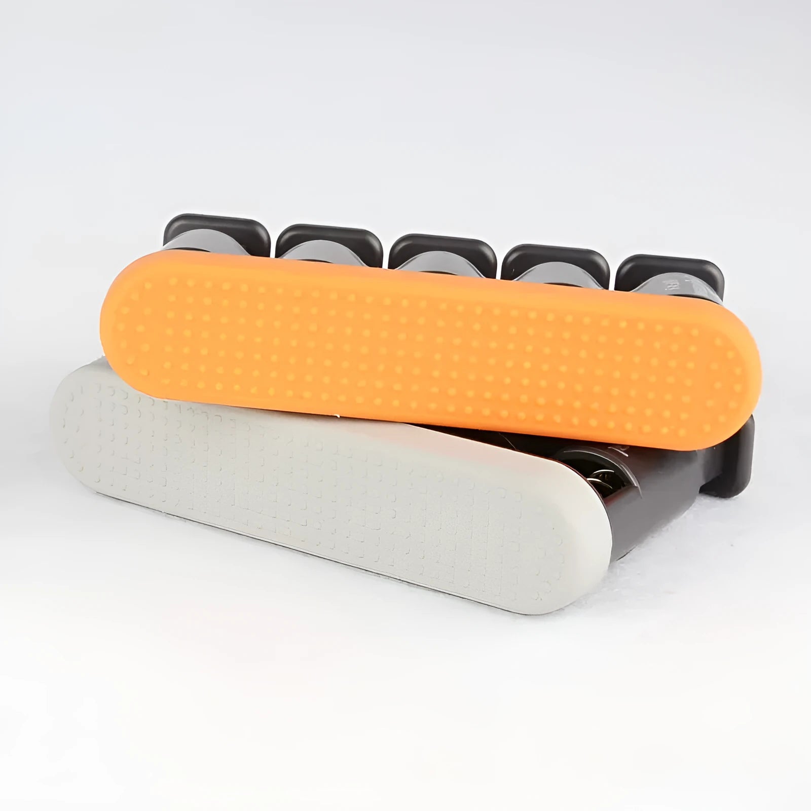 Grey and orange non-slip silicone finger trainer for hand muscle development.