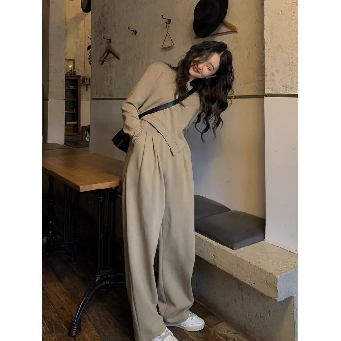 Women's brown loose-fit casual sports suit with long sleeves and full-length trousers on a hanger.
