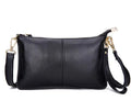 Lady's brown cowhide slant handbag with a long shoulder strap, showing front zip closure.