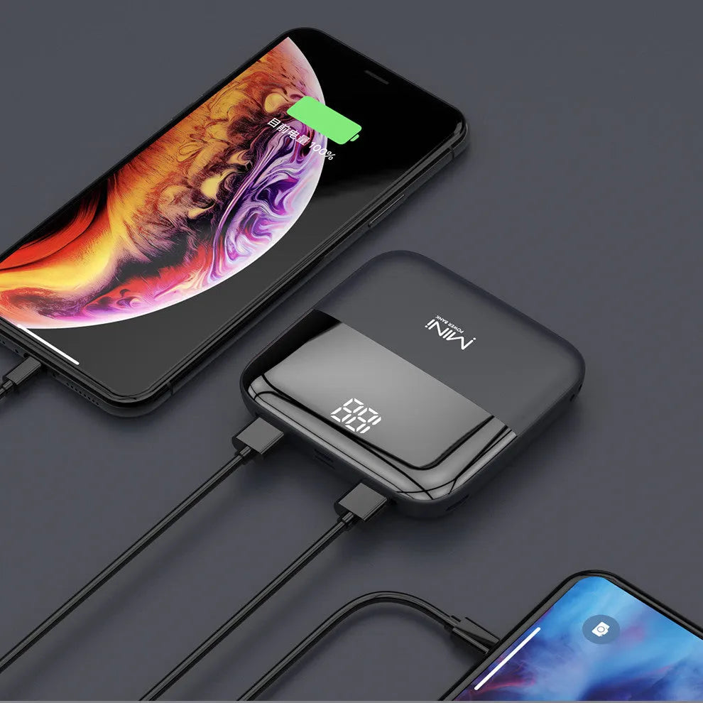 White 10000mAh portable power bank with digital display showing battery percentage and two USB ports.