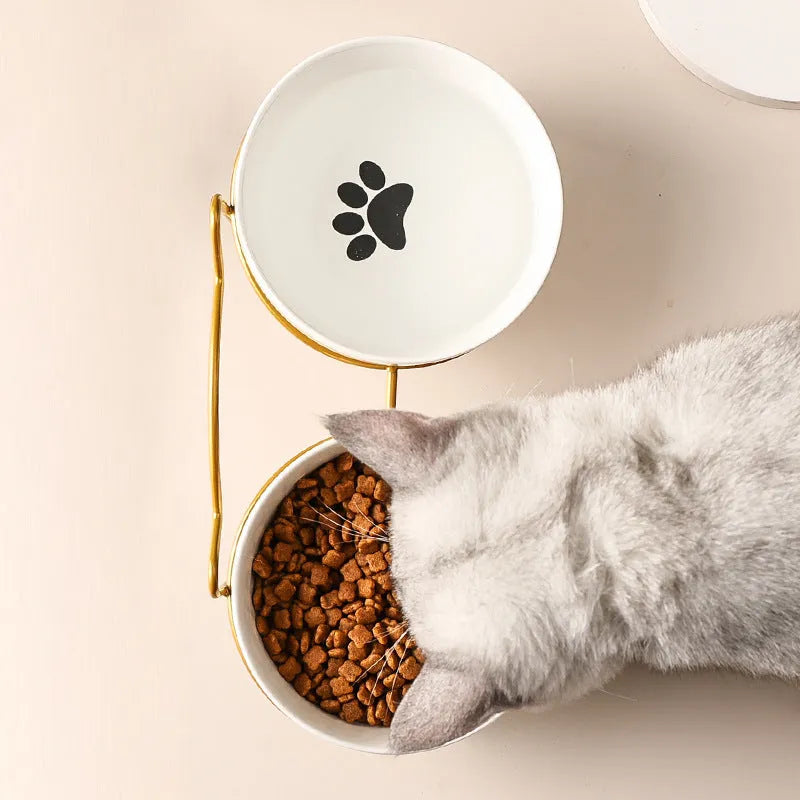White ceramic cat bowl with cat paw design in black iron frame with cat ears