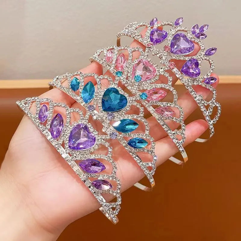 Close-up of a children's metal hairband headdress with a crown pattern in a light purple crystal colour.