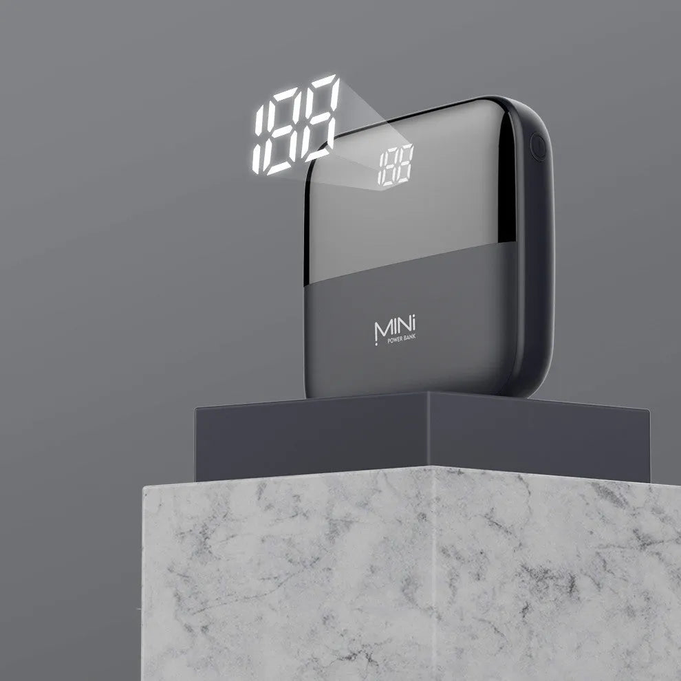 White 10000mAh portable power bank with digital display showing battery percentage and two USB ports.