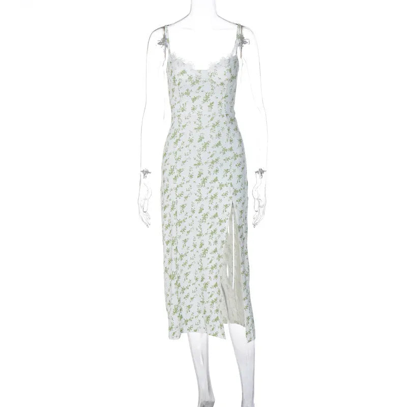 Women's long blue dress with lace flowers print, featuring suspender straps and a thigh-high slit.