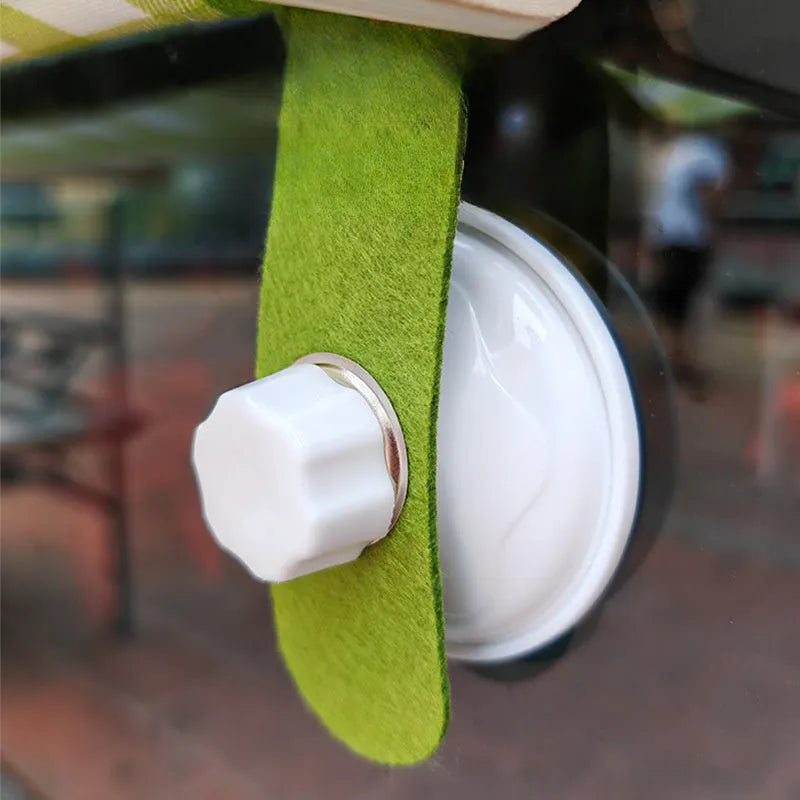 Wooden frame cat window hammock bed with linen fabric attached by suction cups to a window.