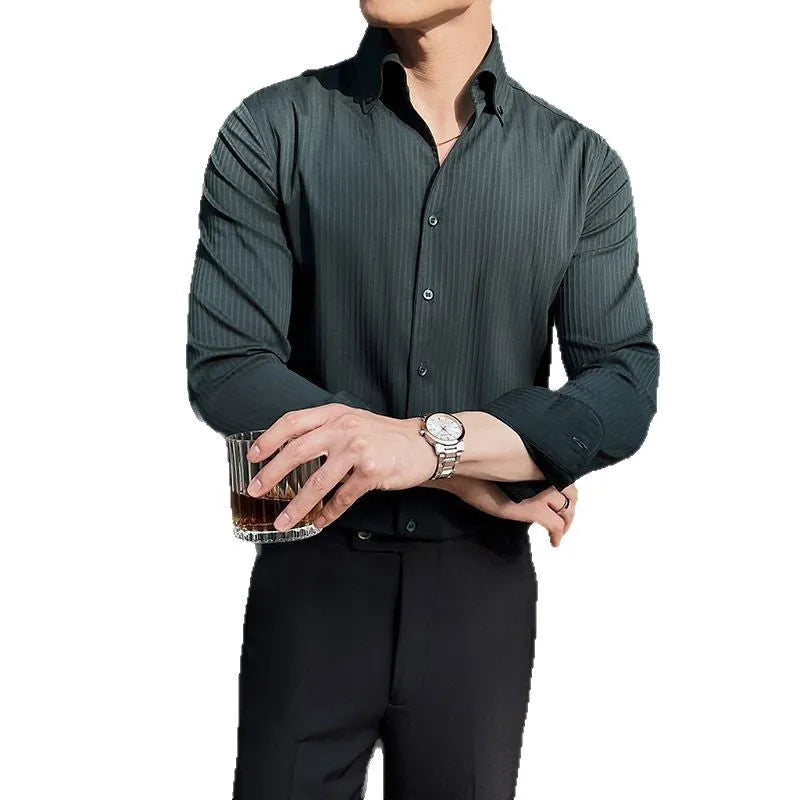 Man wearing a dark striped V-neck long sleeve shirt in a cardigan style.
