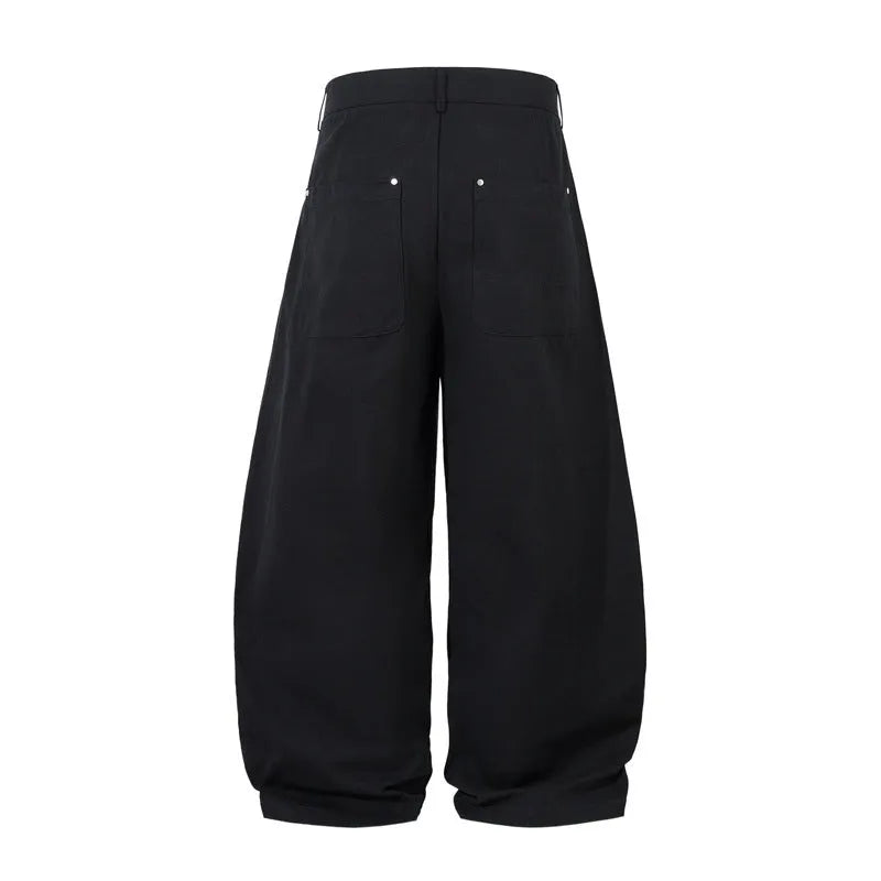 Men's black pleated casual trousers with a loose wide-leg fit and elasticated mid-waist.