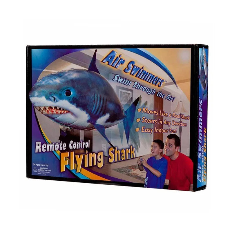 Large remote control shark helium balloon flying indoors with handheld infrared controller.