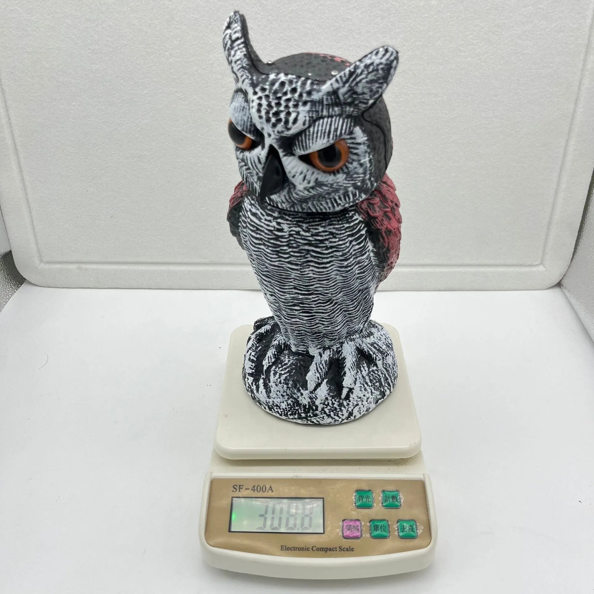 Realistic plastic artificial owl bird deterrent ornament with shaking head, for outdoor use.
