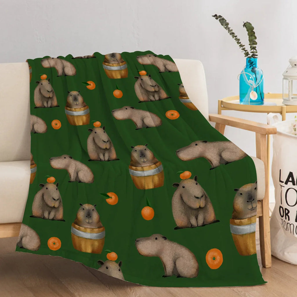Flannel fleece blanket with orange capybara print, soft fluffy throw in three sizes with hemmed edges.