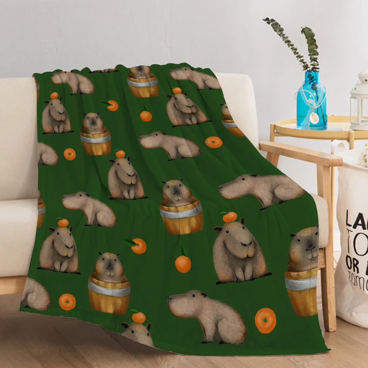 Flannel fleece blanket with orange capybara print, soft fluffy throw in three sizes with hemmed edges.