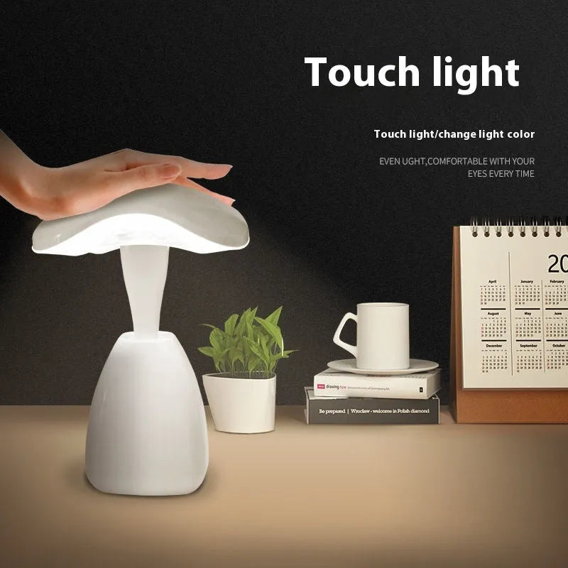 White plastic LED desk lamp with touch controls and built-in battery for bedside use