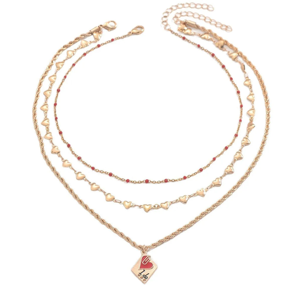 Close-up of a three-layer zinc alloy clavicle chain necklace with geometric shapes and a heart pendant.