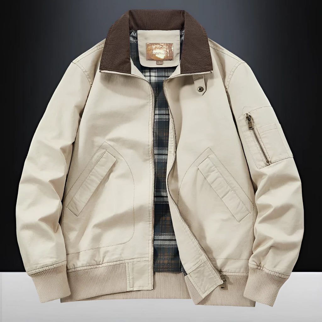 Men's beige washed cotton baseball style flight jacket on a hanger, showing classic design.