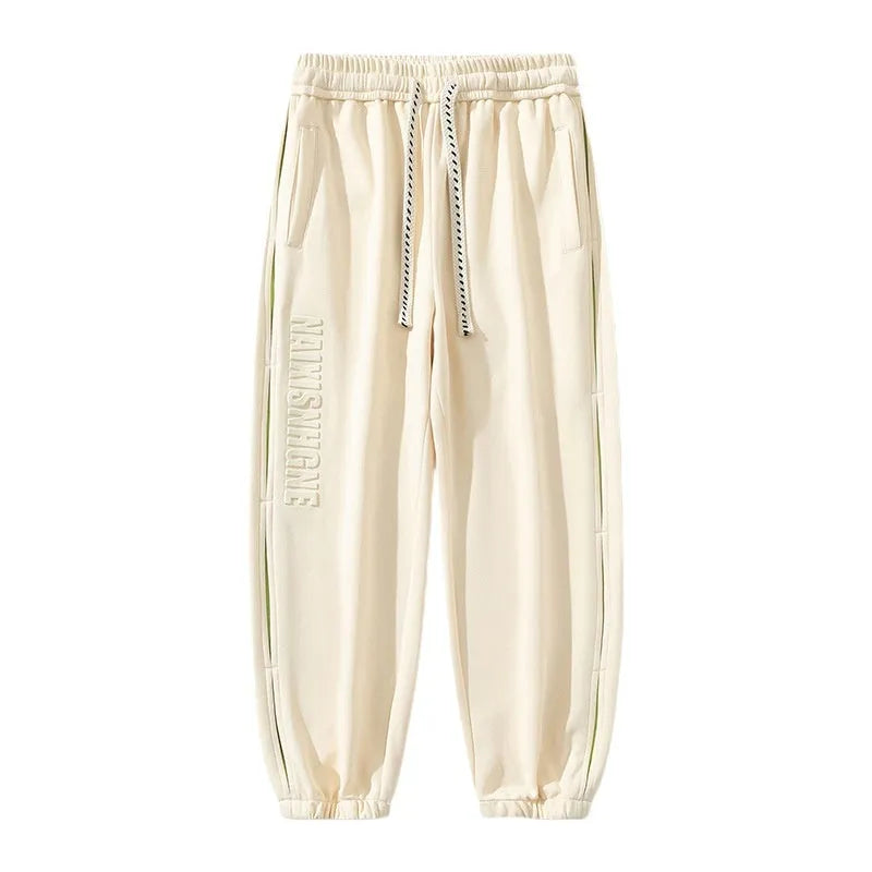 Men's loose-fit ankle banded cotton trousers with stitching detailing and skinny leg opening in grey green colour