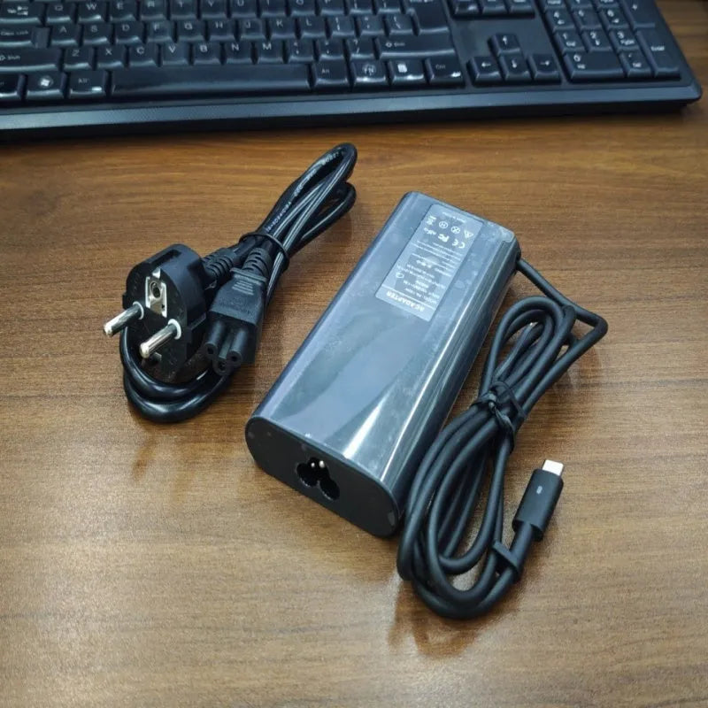 Black oval 65W laptop Type-C charger with six interchangeable international power cords