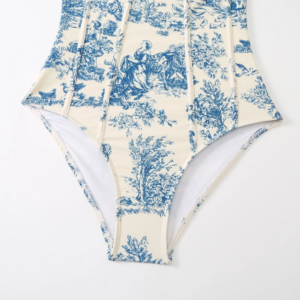 Blue women's one-piece swimsuit with a separate matching gauze skirt laid flat.
