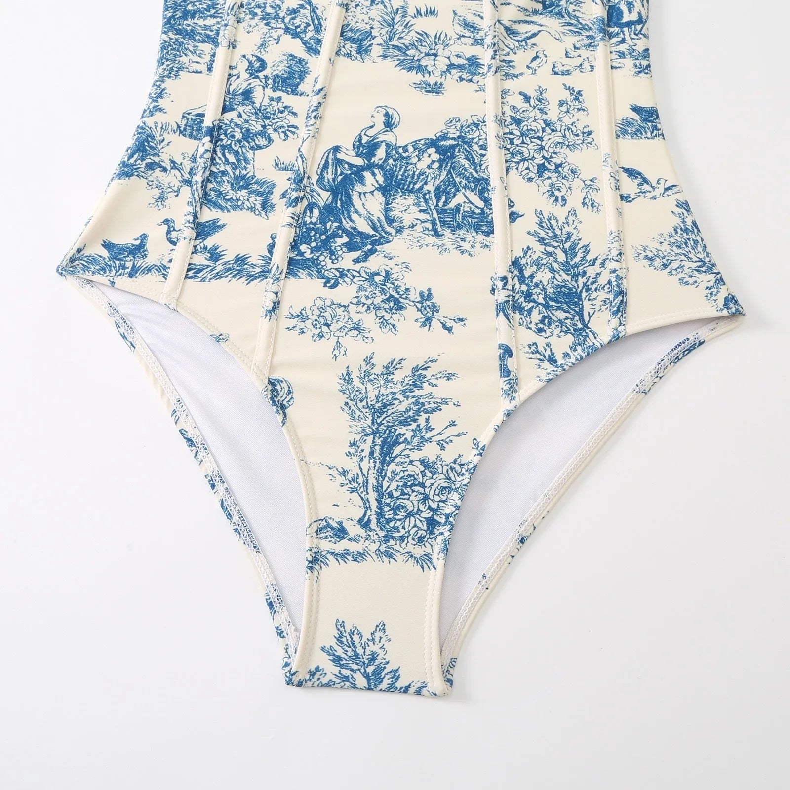Blue women's one-piece swimsuit with a separate matching gauze skirt laid flat.